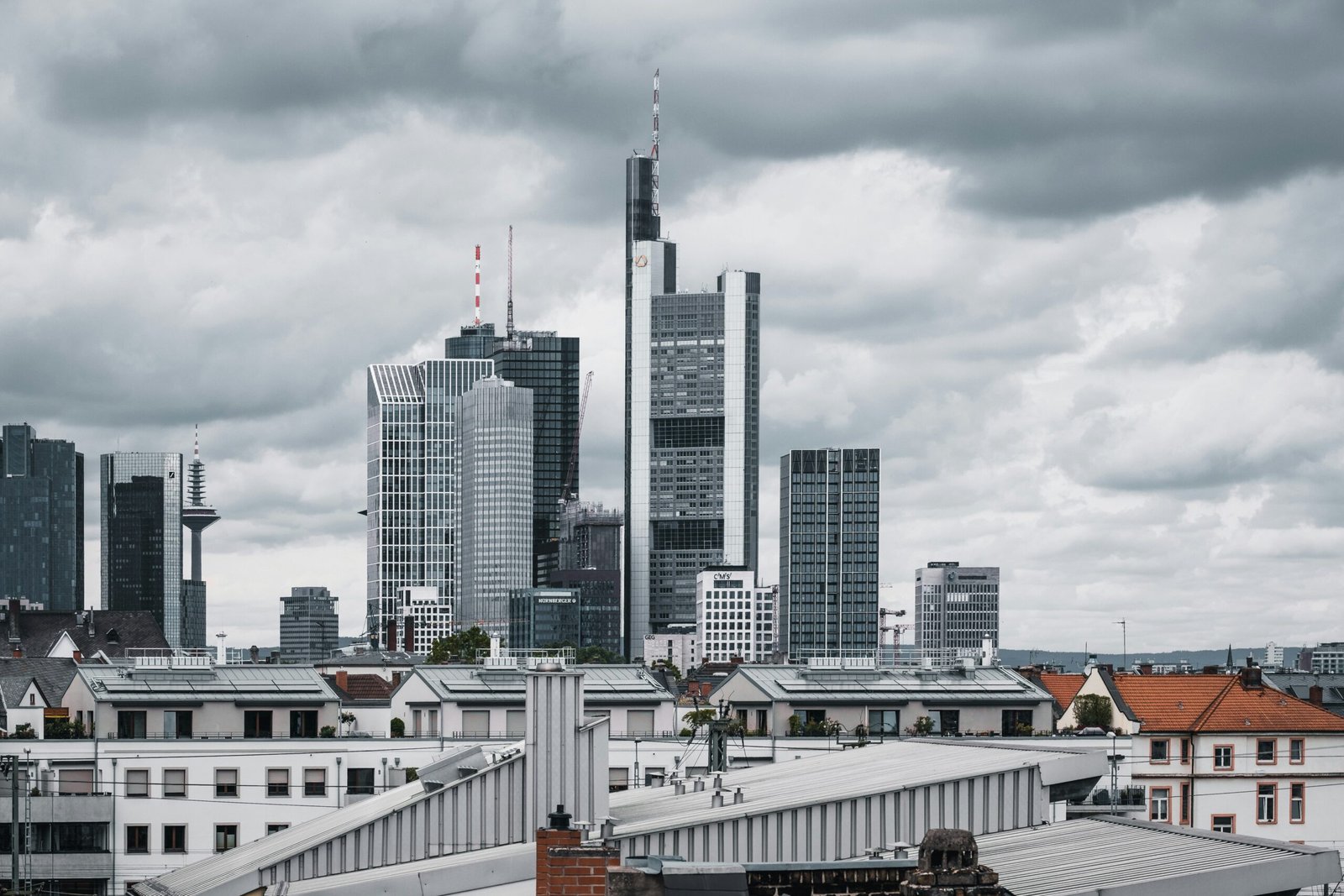 Frankfurt rooftop event space hosting a phygital corporate gathering, blending physical networking with digital insights and panoramic city views.